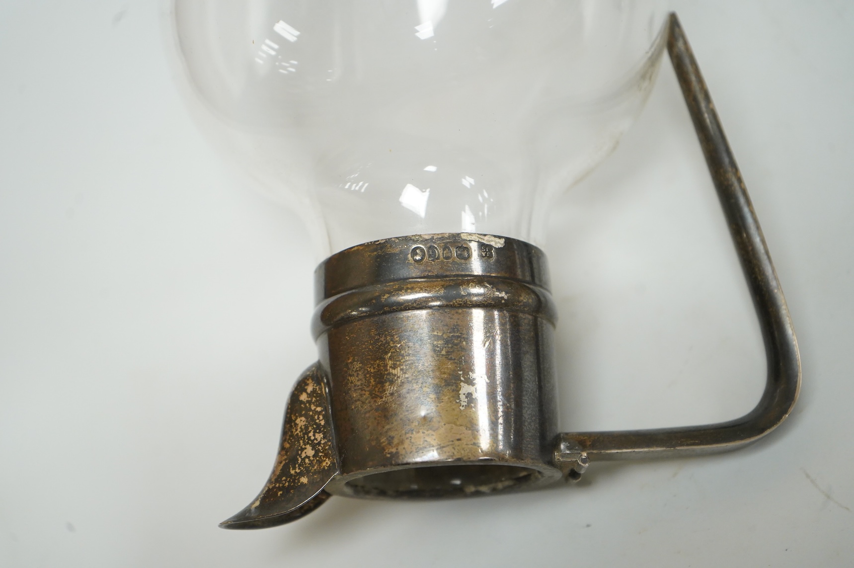 A late Victorian silver mounted claret jug (lacking cover), Holland, Son & Slater, London, 1882, height 21.1cm, together with a sterling sauce ladle, a plated two handled oval pedestal soup tureen and a cased set of six